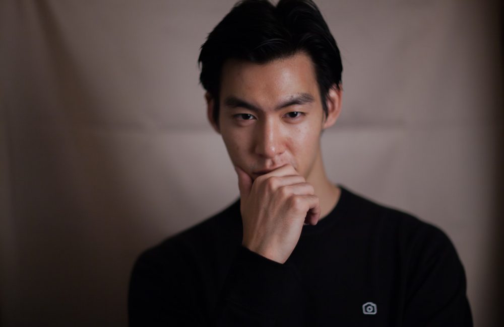 man touching his chin with right hand