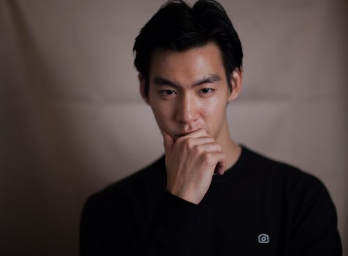 man touching his chin with right hand