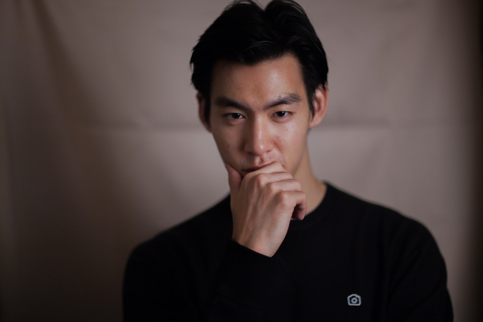 What's the Difference Between Loneliness and Solitude? 1 man touching his chin with right hand