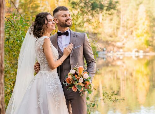 man in gray suit and woman in white wedding dress