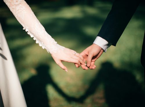 man and woman holding hands focus photo