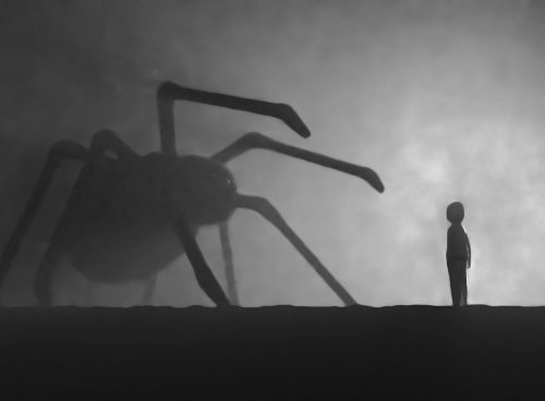a person standing in front of a giant spider