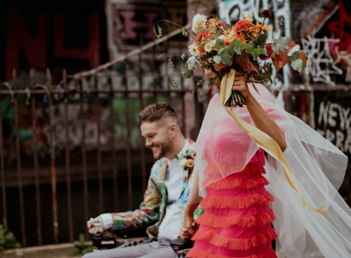 a man riding a bike down a street next to a woman