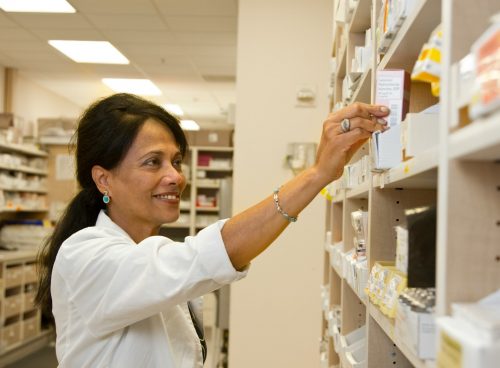 man in white dress shirt holding white box