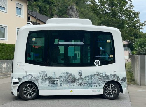 a white bus parked on the side of a road