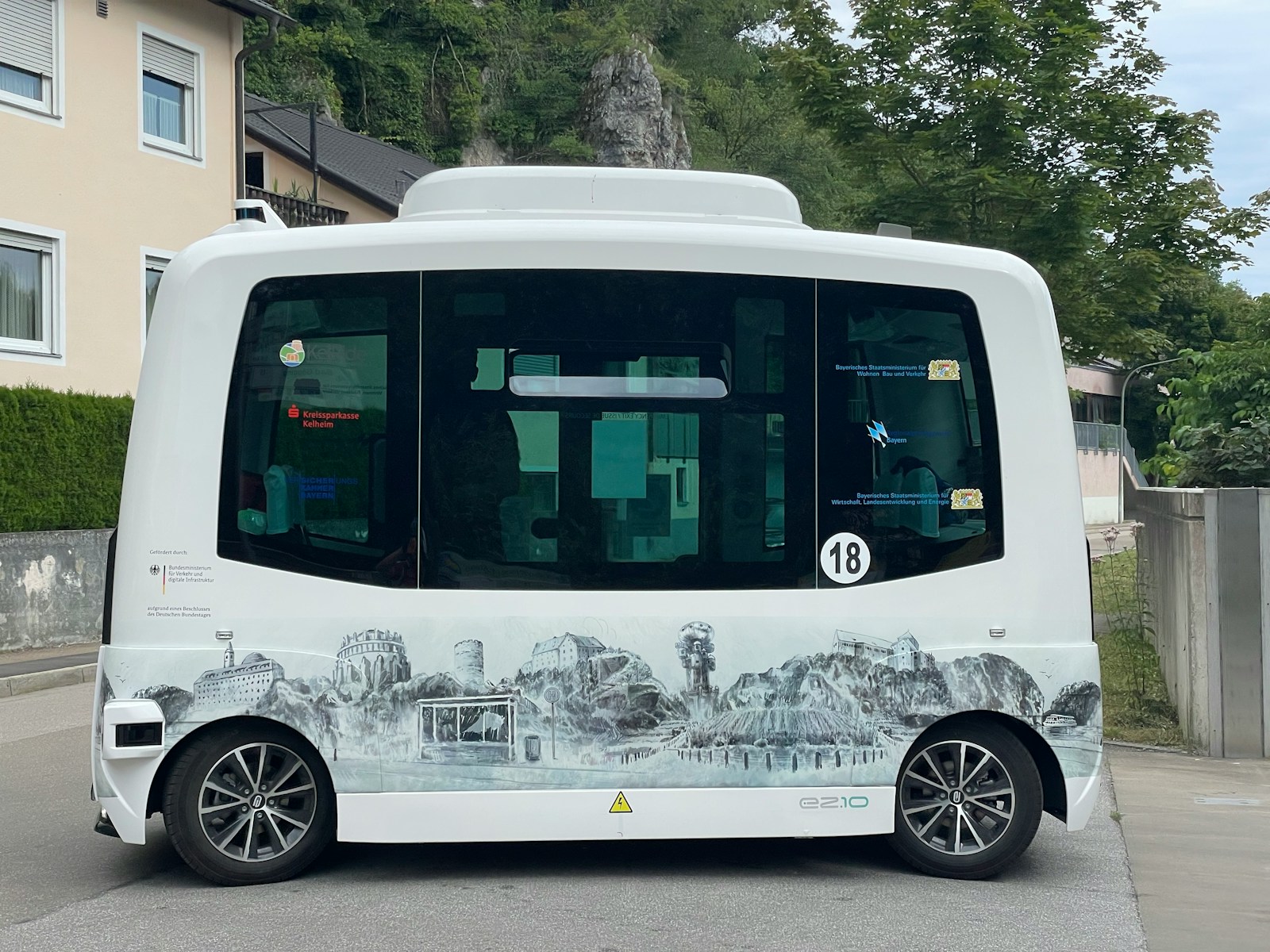 How Does Self-Driving Technology Work? 1 a white bus parked on the side of a road