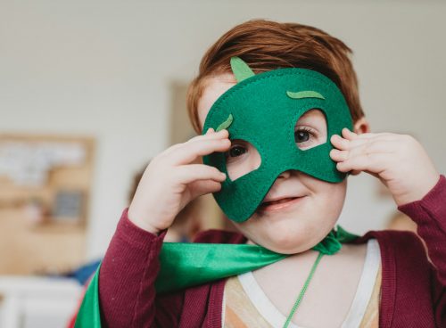 boy holding green mask