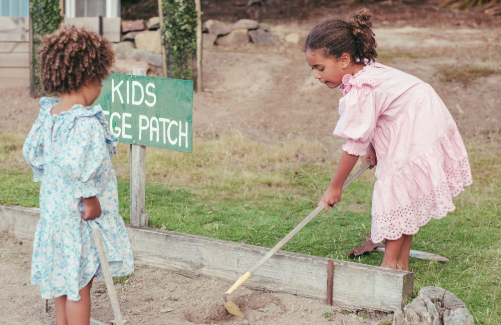 a couple of girls cleaning the ground