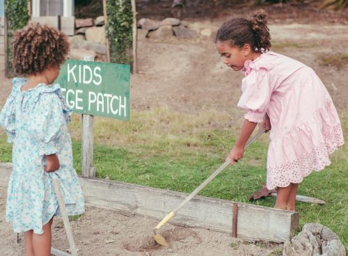 a couple of girls cleaning the ground