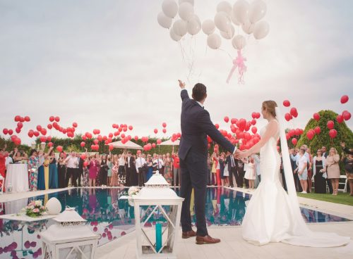 photo of a man and woman newly wedding holding a balloons