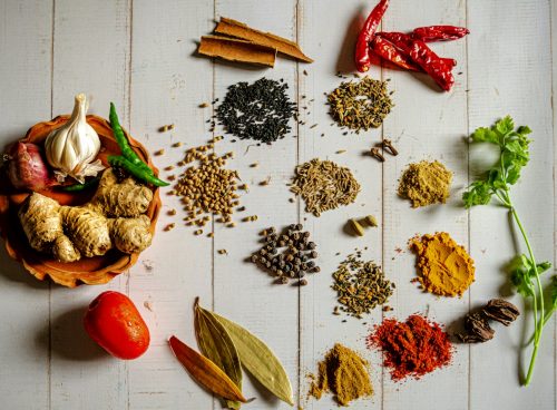 a variety of spices on a white table