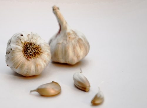 garlic bulb and garlic on white surface