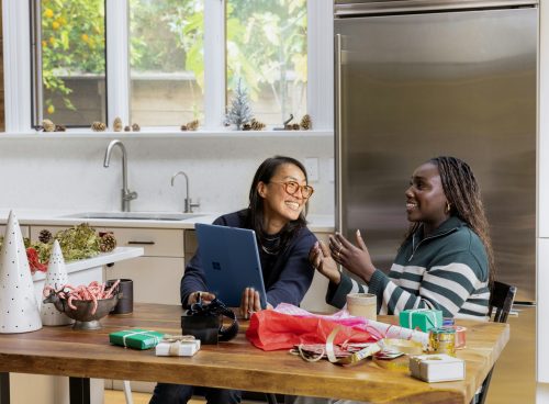 a woman sitting at a table in front of a window