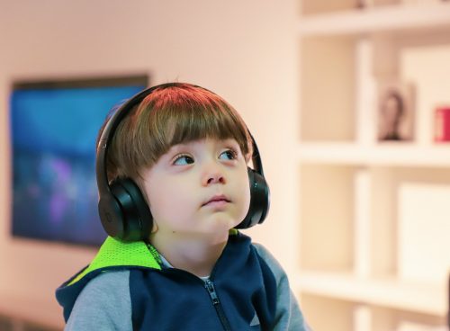 boy near white wooden shelf