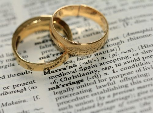 two gold-colored rings on paper