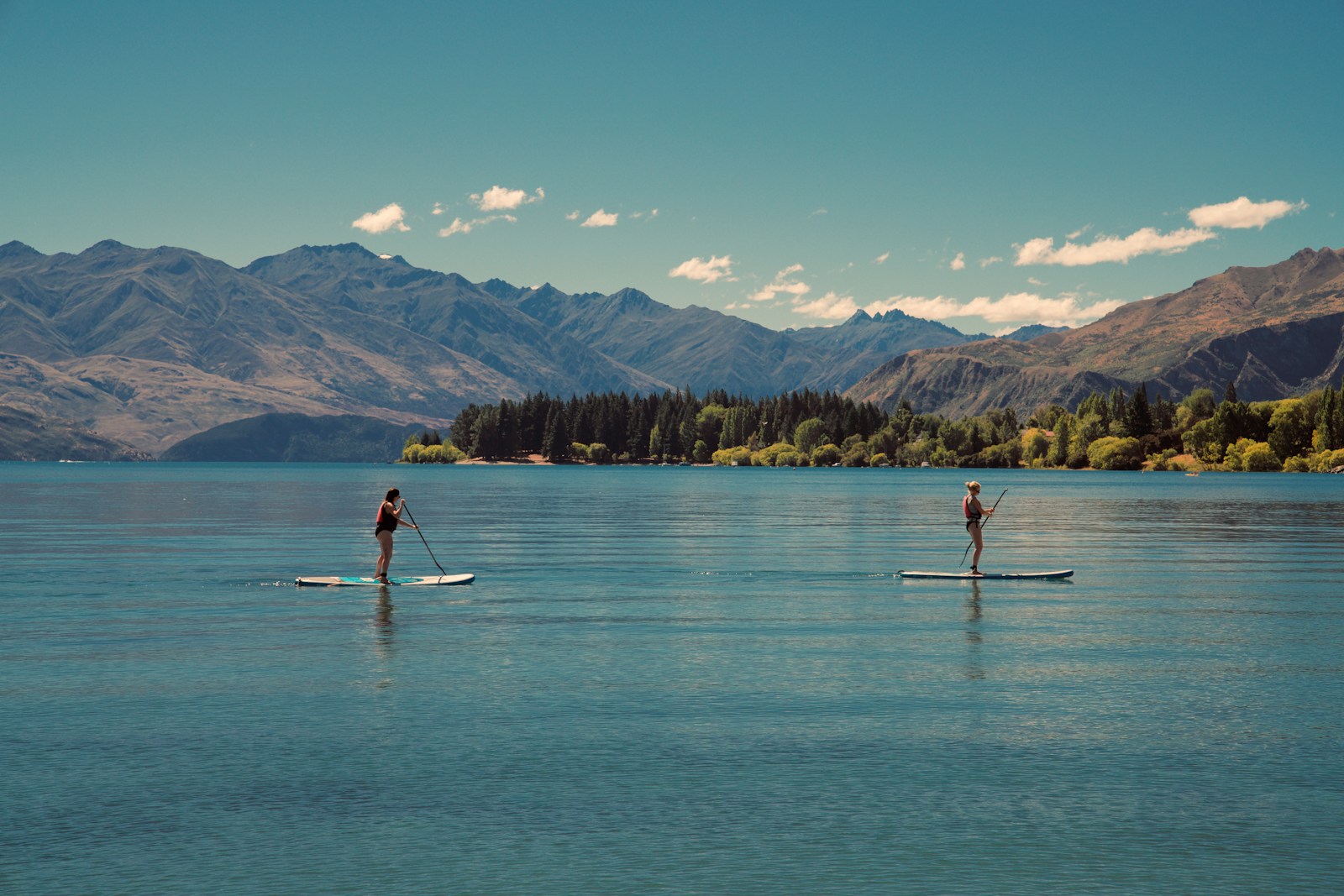 13 Best Places to Visit for Stand-Up Paddleboarding 1 two person riding on paddle boards during daytime