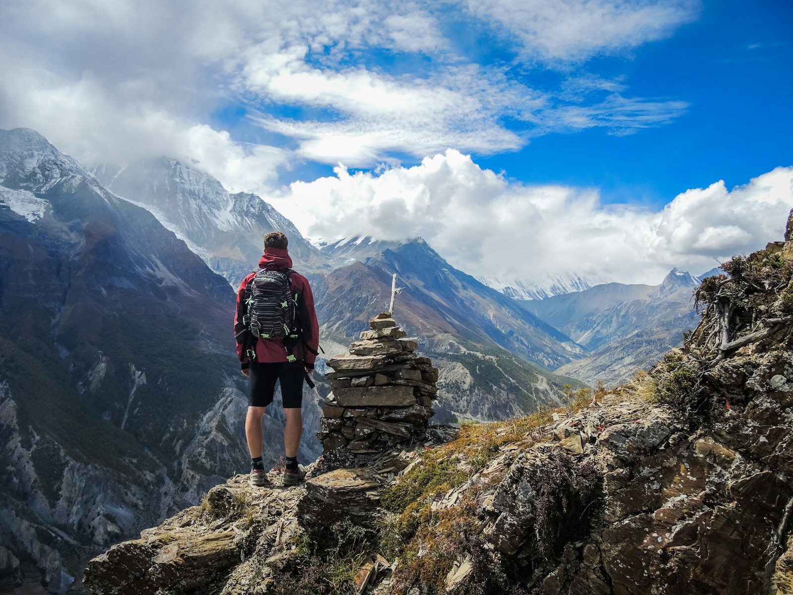 How to Create a Budget-Friendly Travel Plan 1 man standing on top of mountain beside cairn stones