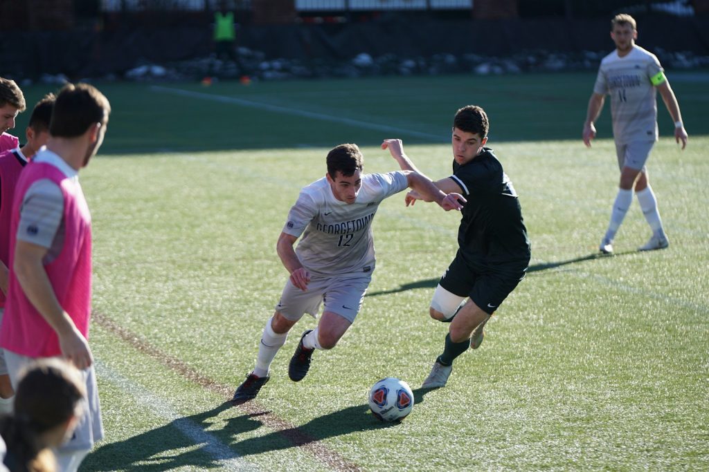 15 Sports and Exercises that Promote Height Growth in Teenagers 5 man playing soccer on the field