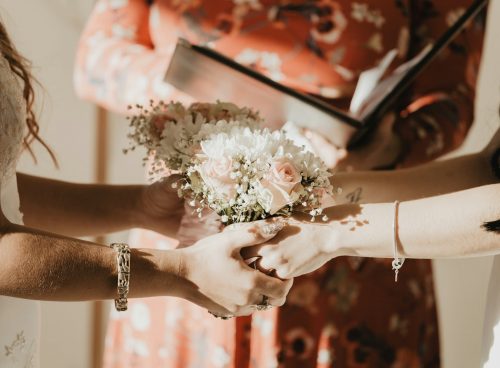 person holding white flower bouquet