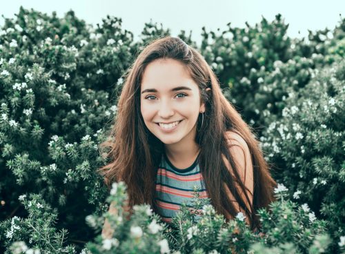 woman standing in bushes