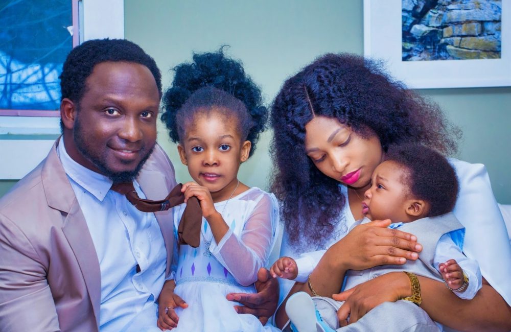 a man, woman, and child are posing for a picture