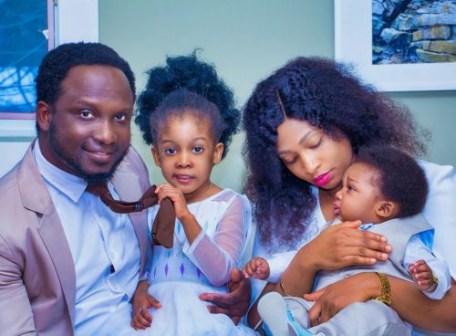 a man, woman, and child are posing for a picture