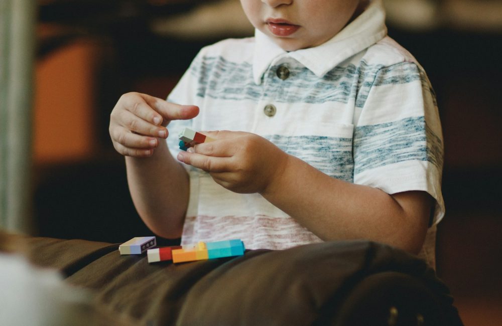 boy holding block toy