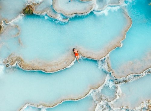 man sitting in body of water