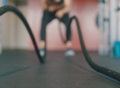 person holding black exercise rope