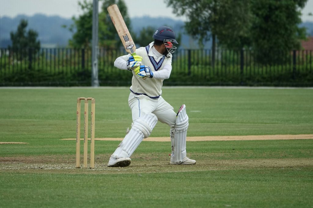 15 Sports and Exercises that Promote Height Growth in Teenagers 12 baseball player in white and blue jersey shirt and white pants holding baseball bat during daytime