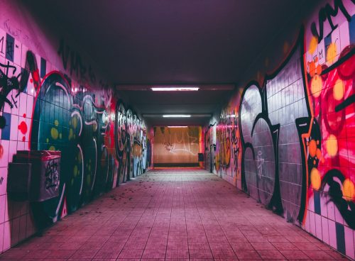 empty tunnel pathway with graffiti walls