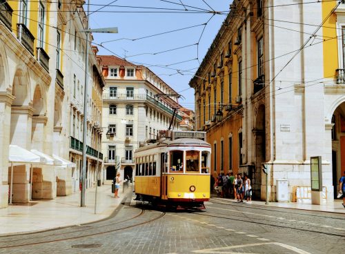 yellow and white tram on road during daytime