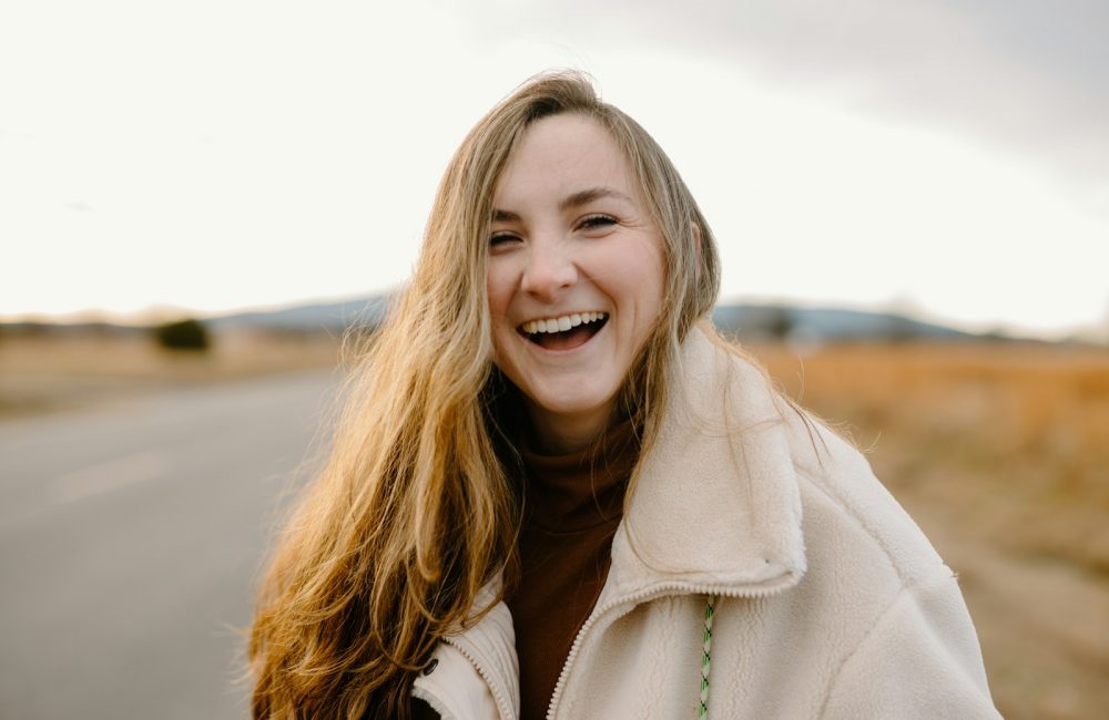 smiling woman in green jacket