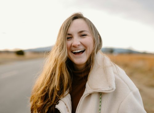 smiling woman in green jacket