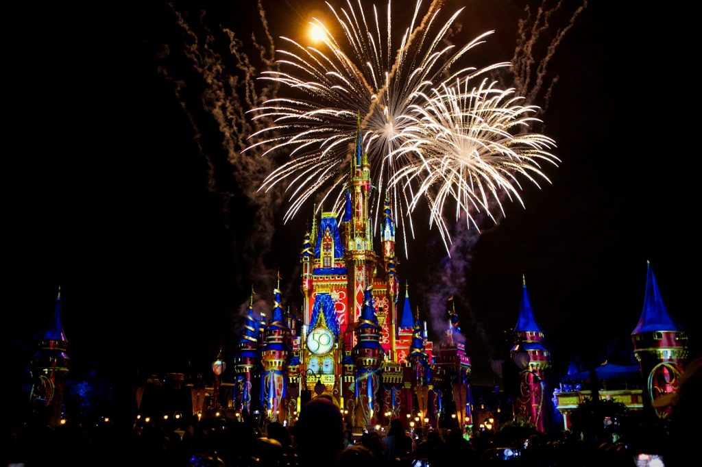 14 Best Places to Visit for Theme Parks 2 a castle is lit up with fireworks at night