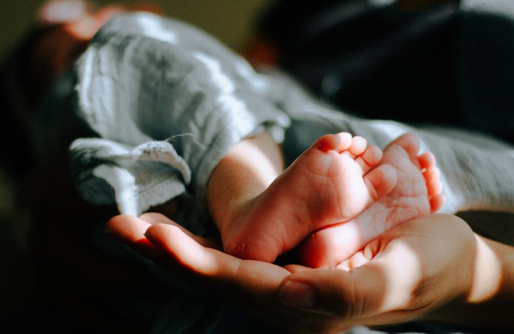 person holding baby feet