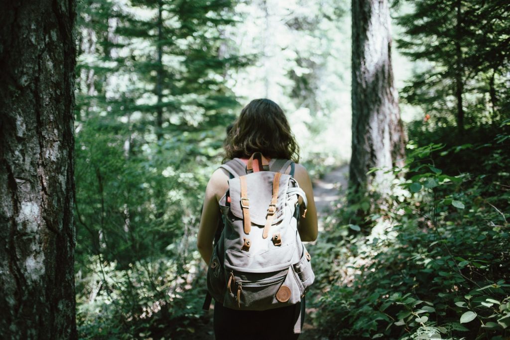 15 Sports and Exercises that Promote Height Growth in Teenagers 16 woman in sleeveless top and backpack surrounded by trees during daytime