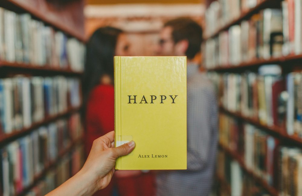 person holding Happy by Alex Lemon book