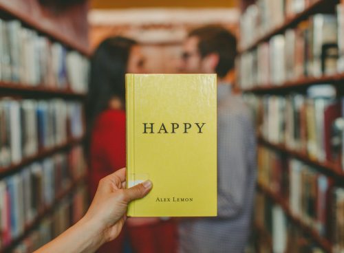 person holding Happy by Alex Lemon book