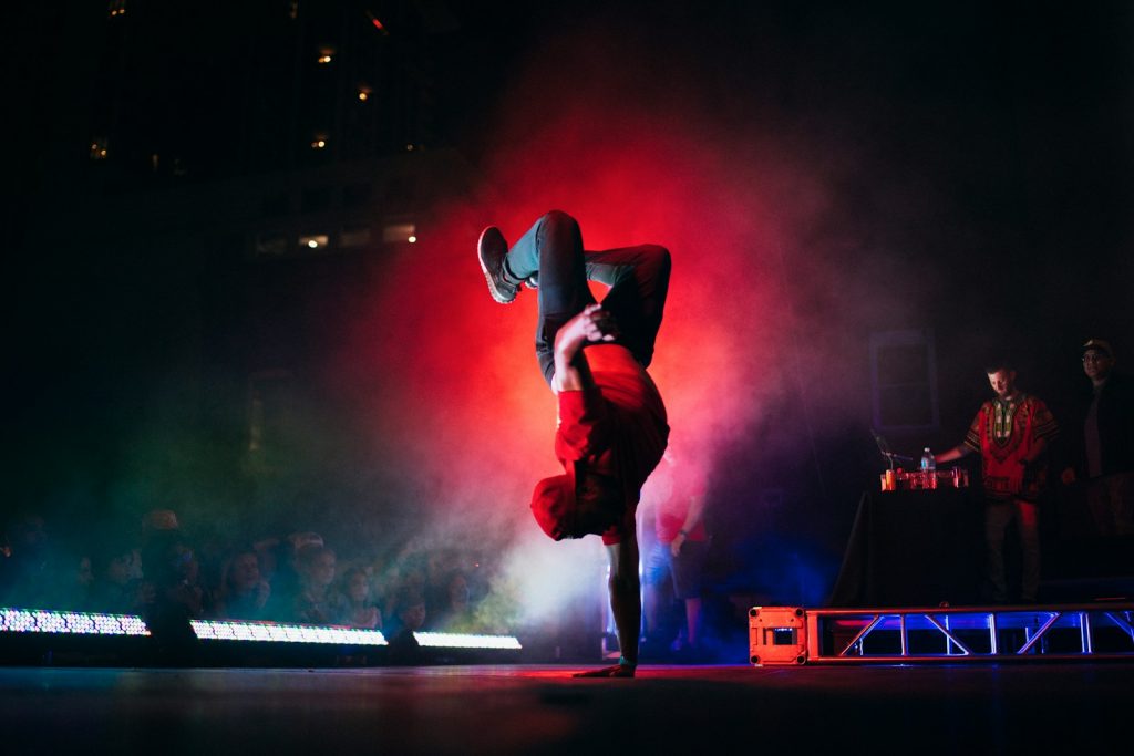 15 Sports and Exercises that Promote Height Growth in Teenagers 15 man doing breakdancing on gray surface
