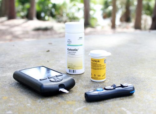black smartphone beside white plastic bottle and black smartphone