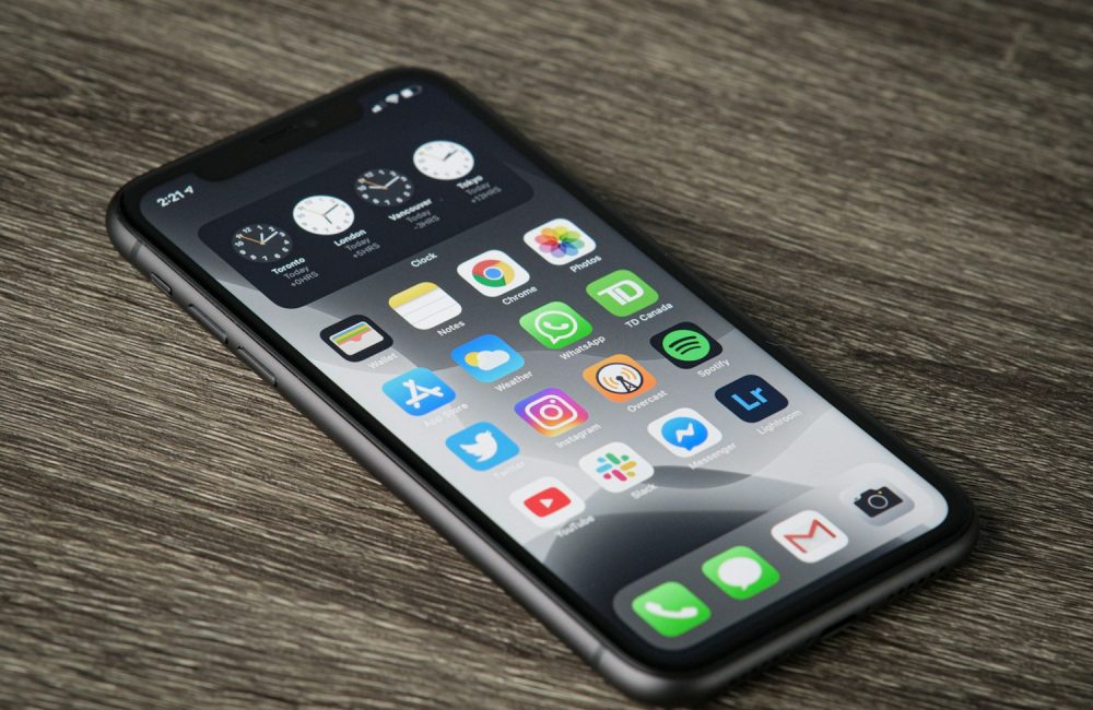 black iphone 5 on brown wooden table