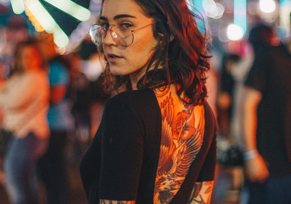 portrait photography of woman standing near Ferris Wheel