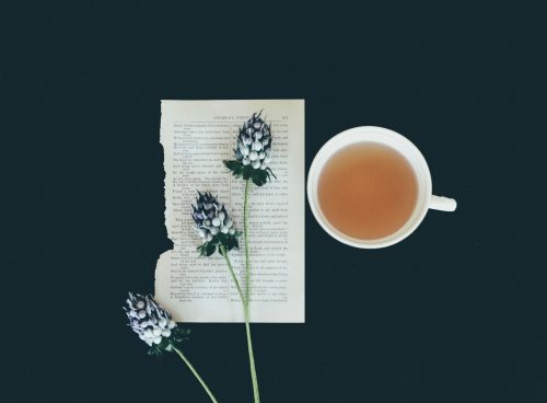 white ceramic tea cup beside white flowers