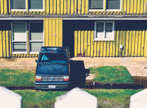 blue pickup truck packed on green grass