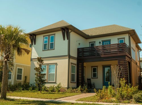 a two story house with a balcony and balconies