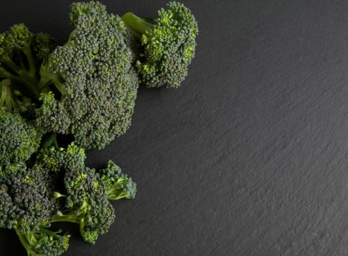 green broccoli on black textile