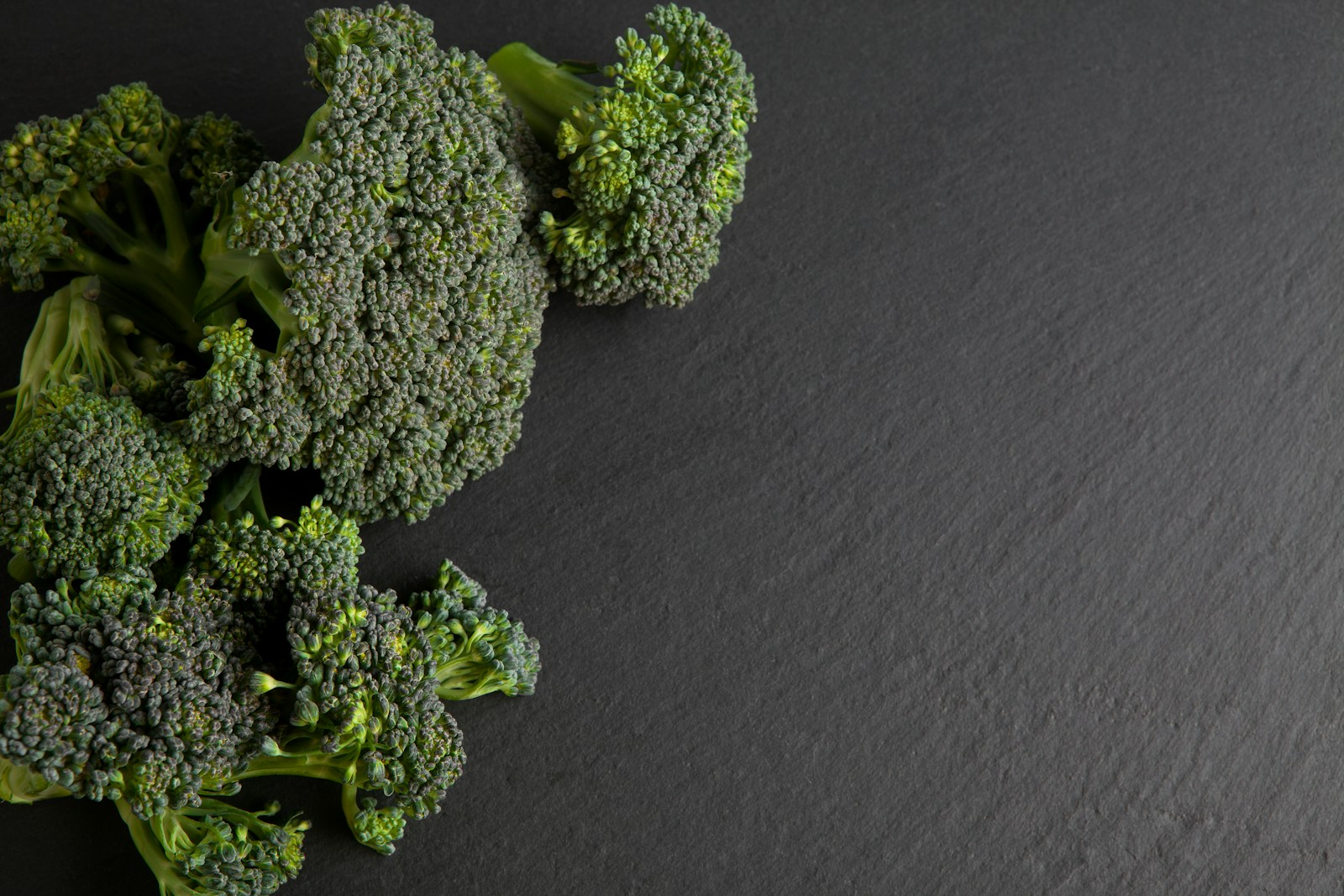 green broccoli on black textile