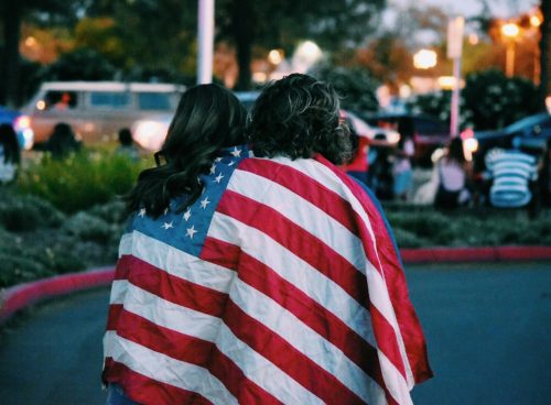 woman and man covered USA flag