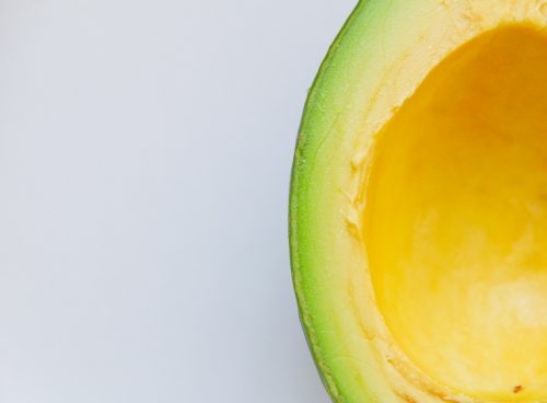 sliced avocado against white background